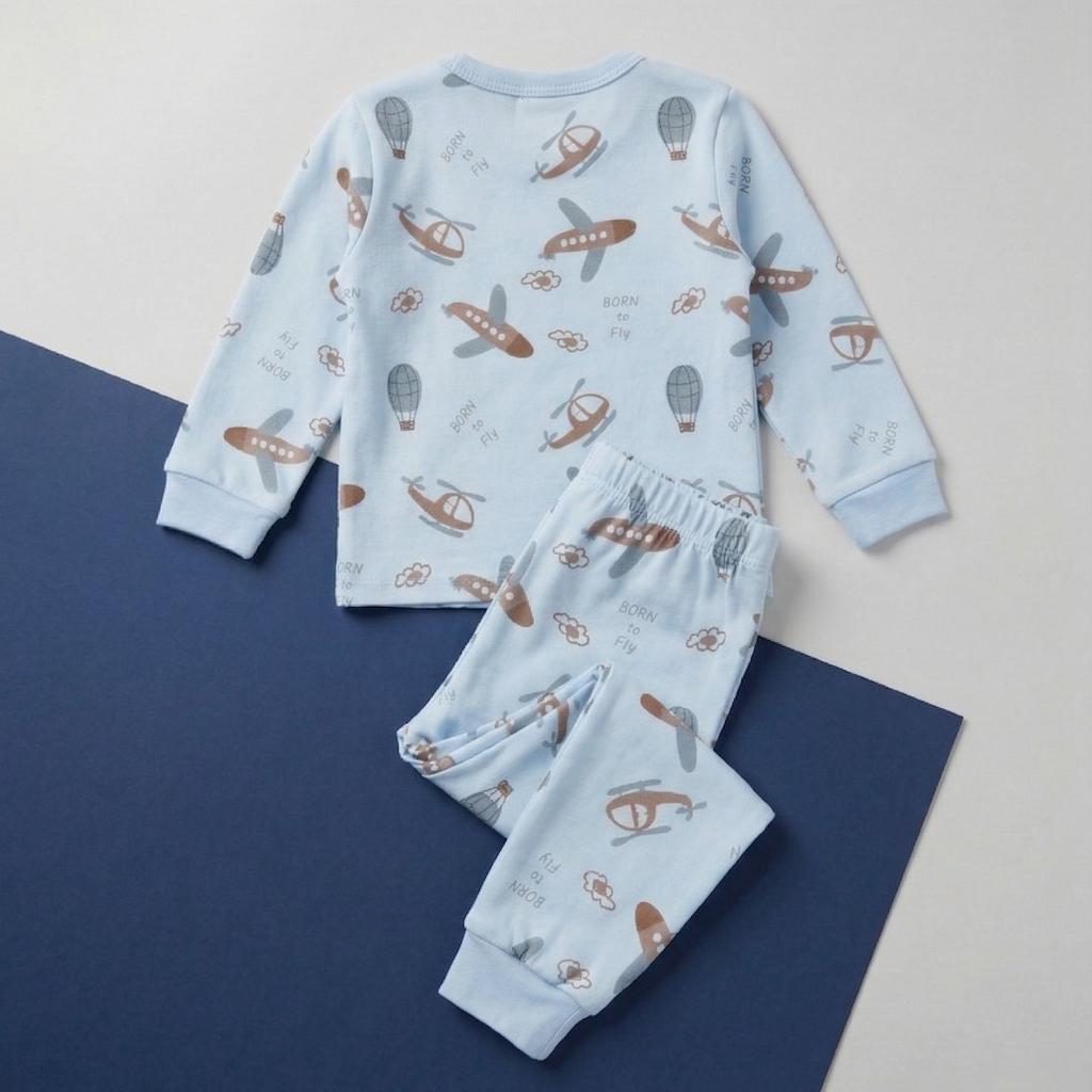 Children's pajama set with airplane pattern on a blue surface