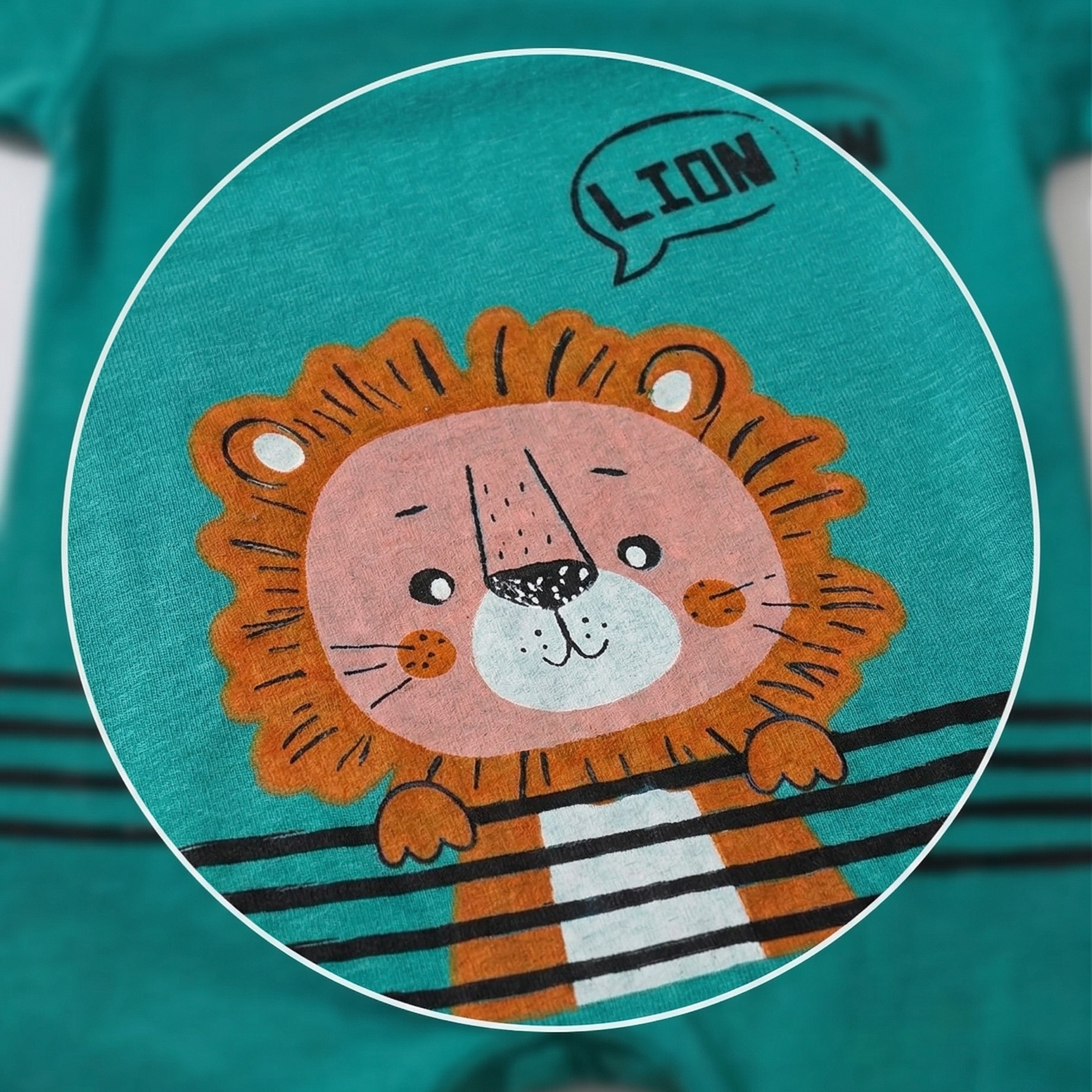 Teal t-shirt with a lion graphic and 'LION' text on a white background