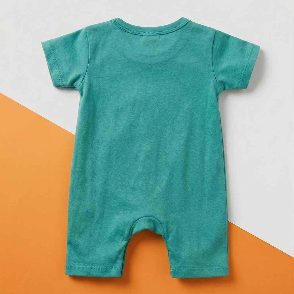 Green baby romper on a white and orange background